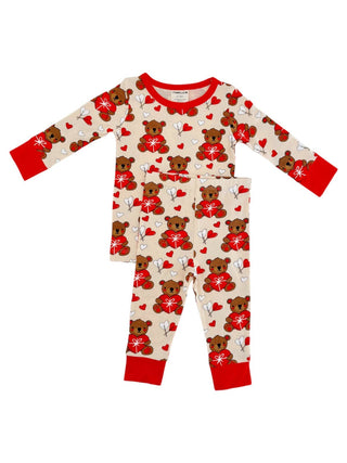 The SpearmintLOVE Long Sleeve 2-Piece Set - Valentine Bear is a cream pajama set perfect for family matching, featuring long sleeves, red cuffs and neckline, and a cute design of teddy bears with red bows amidst scattered white hearts.